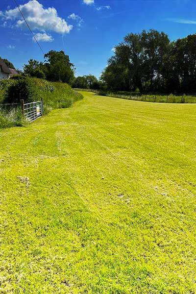 grass field with mats and mesh underneath