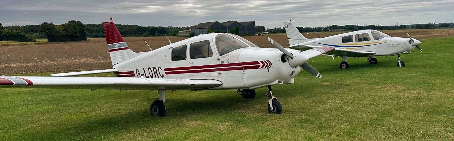2 planes parked on a field, reinforced with grass mesh
