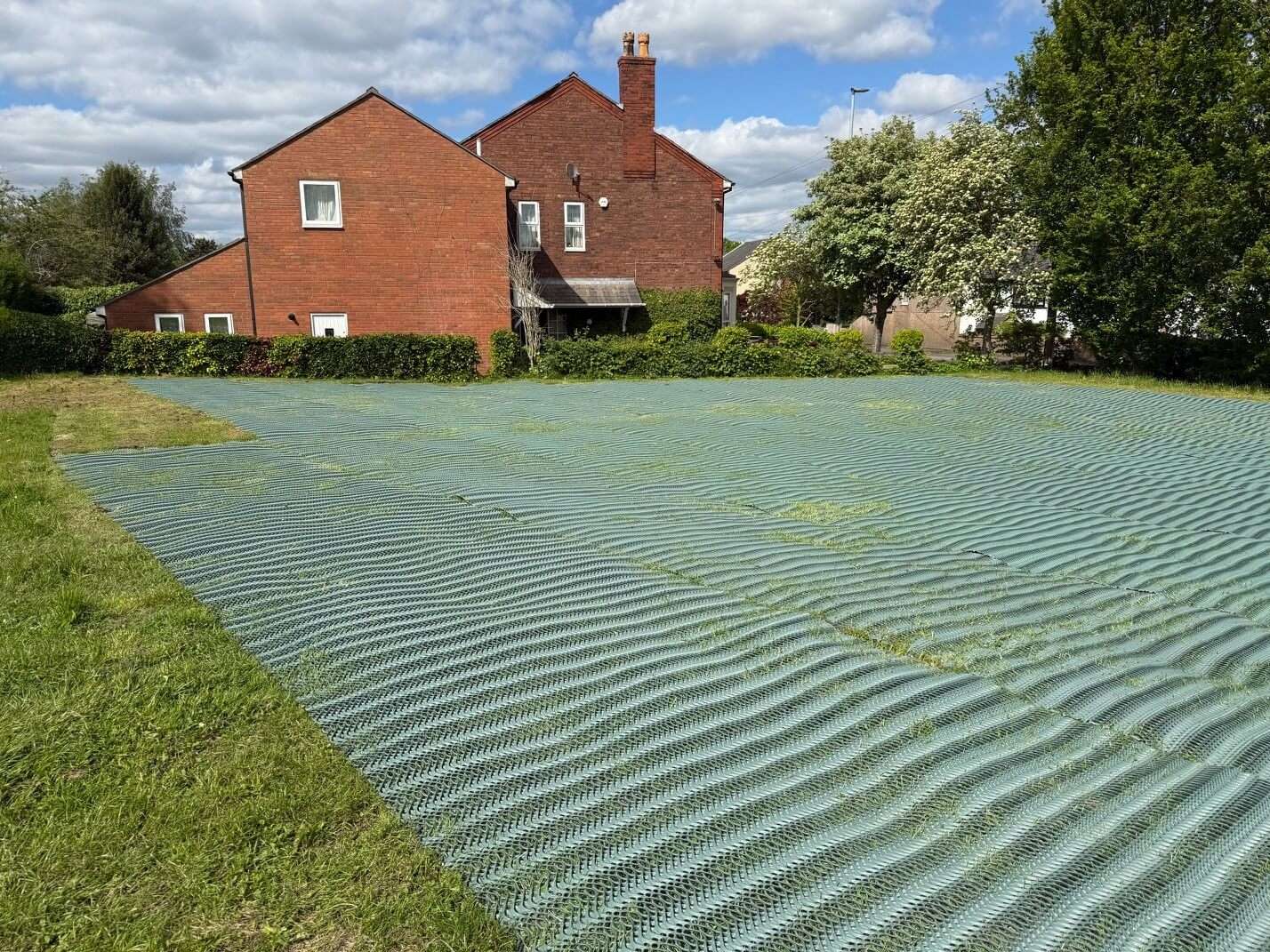 Grass reinforcement mesh installed beside the existing church car park