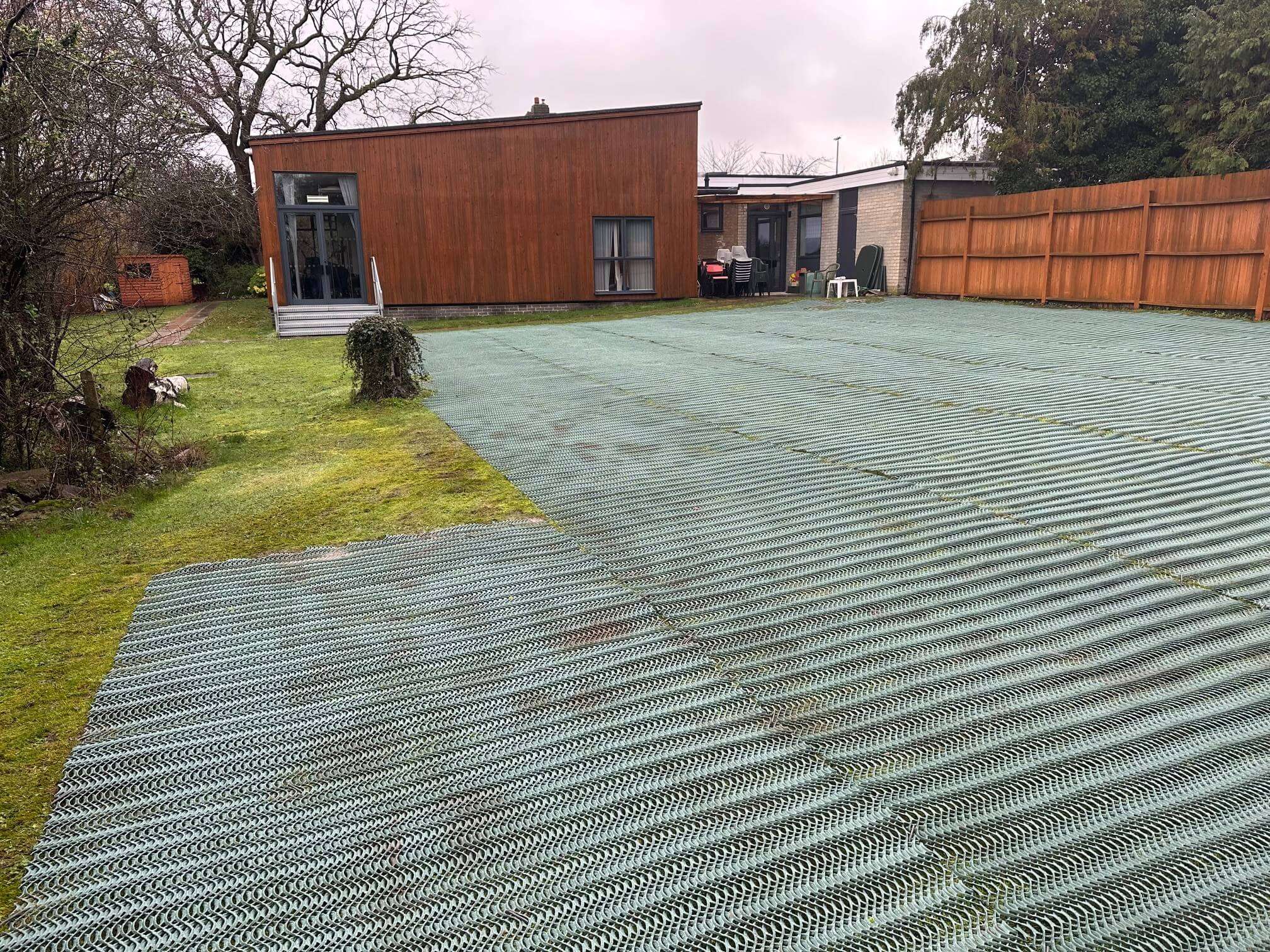 Heavy grass reinforcement mesh installed across a church grass parking area