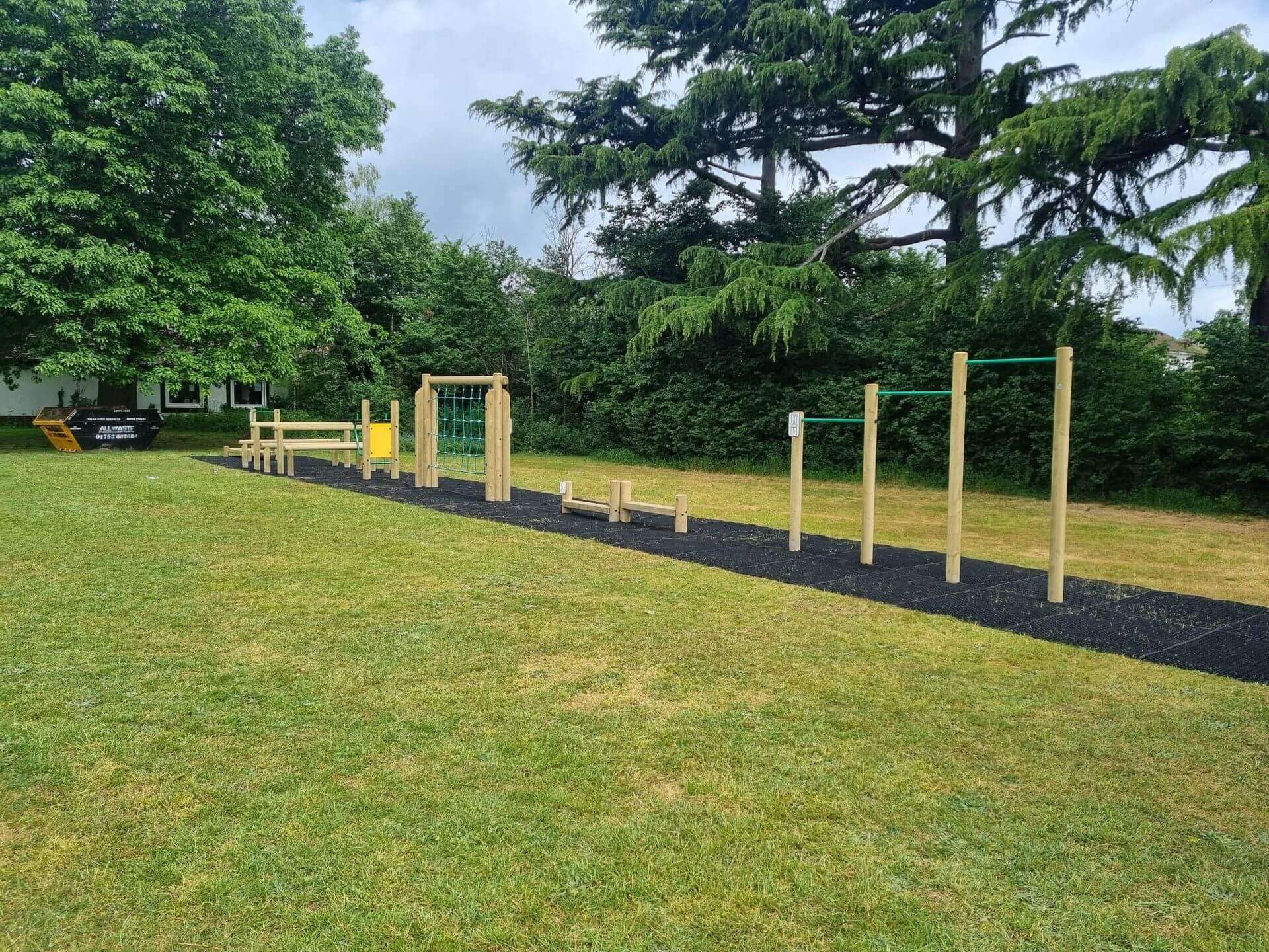 Completed outdoor trim trail with rubber grass safety mats installed