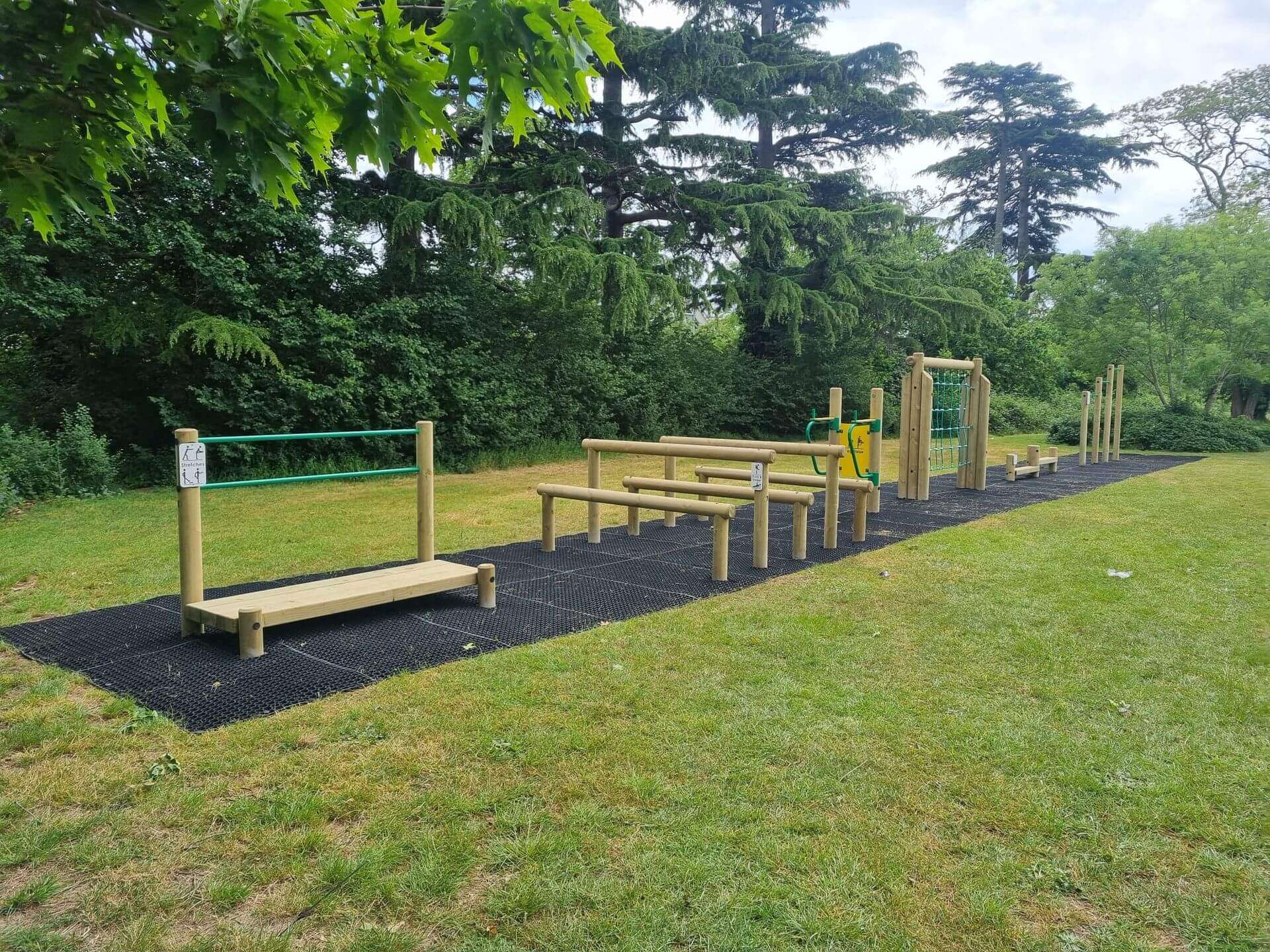 22mm playground safety grass mats installed beneath outdoor fitness equipment