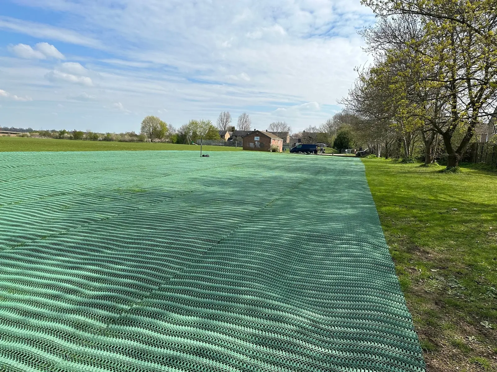Grass reinforcement mesh installed across an open football club grass area